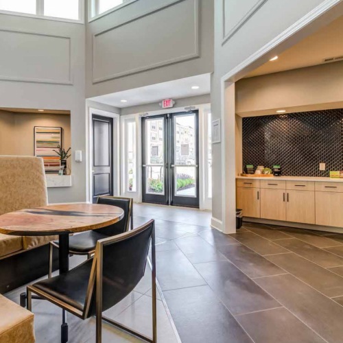 resident lounge with large open spaces, seating, and a coffee bar