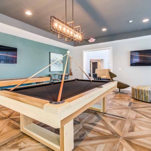 game room with shuffle board, a pool table and seating